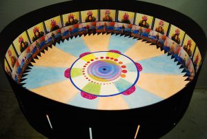 A zoetrope is one of several pre-film animation devices that produce the illusion of motion by displaying a sequence of drawings or photographs showing progressive phases of that motion.